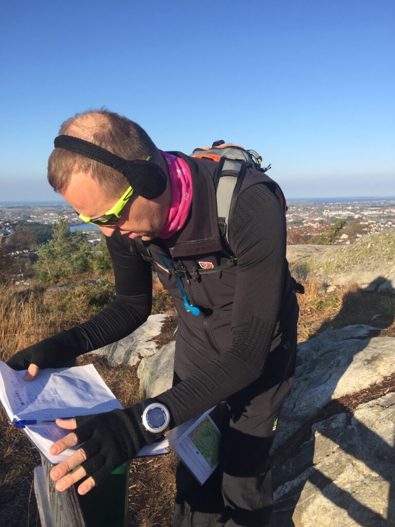 Examining entries in a trekking guestbook, while on a field trip. (Sandnes, Norway, October 2018; Photo by Johan Edelheim)