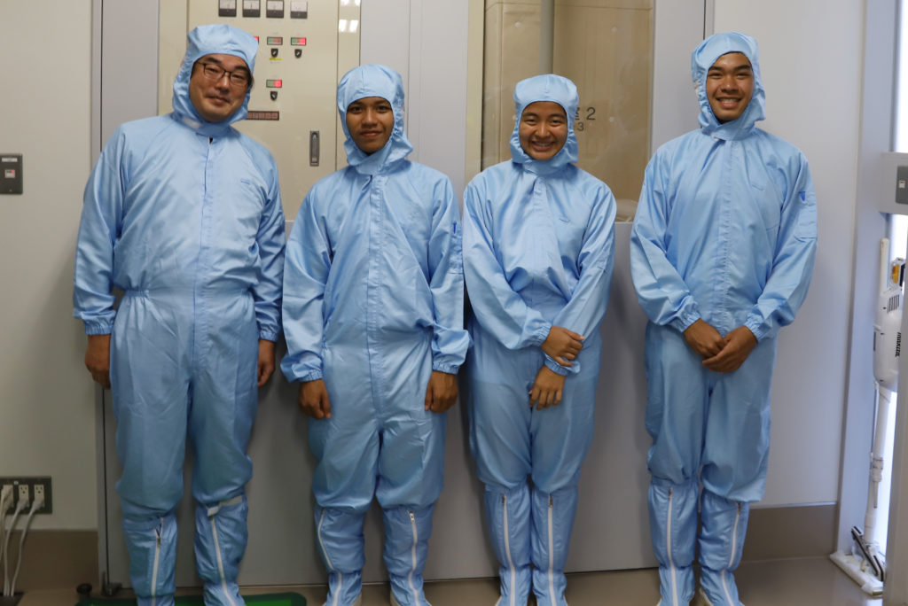 Dr. Abe and some of the students wearing clean suits