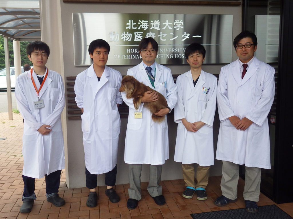 Konnai’s research team with a dog cured of cancer.