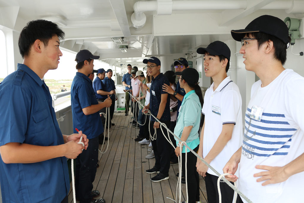 Participants learning the basics of rope-works from crew members.