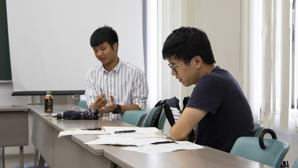 Master’s student Chen Shi discussing policy making with one of his classmates.