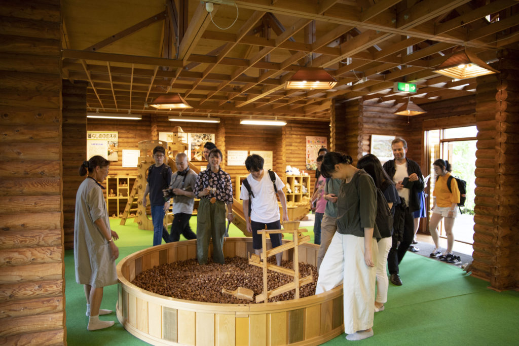 The course participants exploring a nursery primarily made of wood at the Forest Products Research Institute