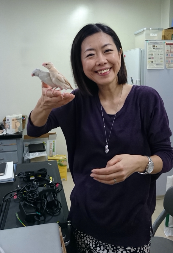 Dr. Soma holding Java sparrows on her hand 