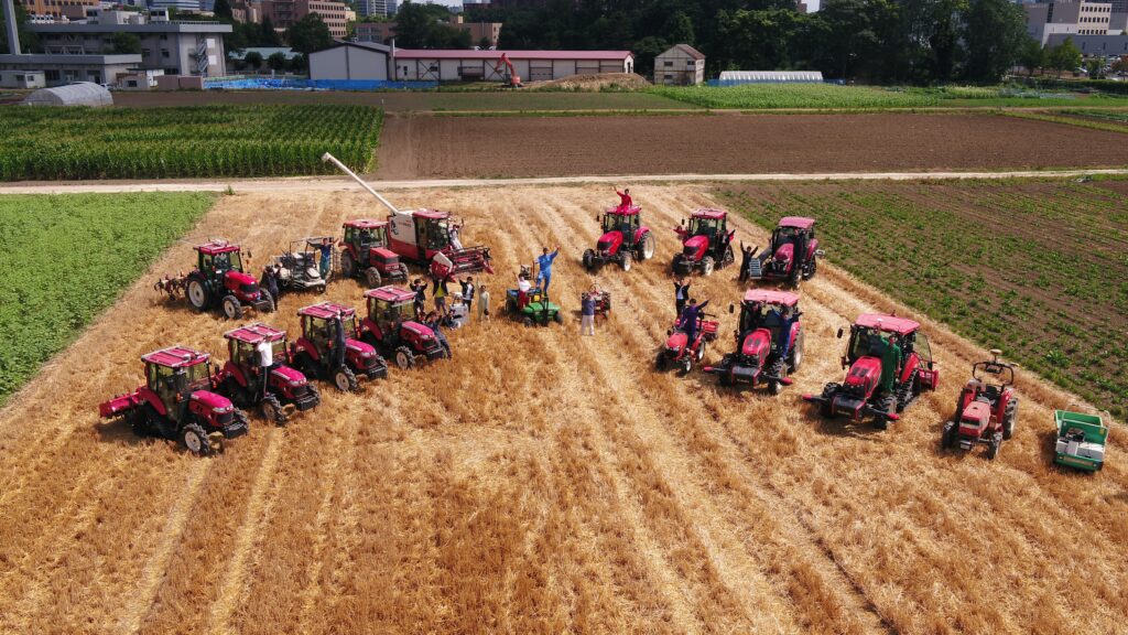 Unmanned agricultural tractors and members of the Laboratory of Vehicle Robotics.