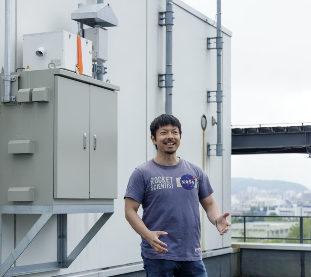 Teppei J. Yasunari. Associate Professor & Distinguished Researcher, Arctic Research Center. The white box with the orange belt at the top left is a commercial version of the PM2.5 measurement system for cold regions of which he led the development.