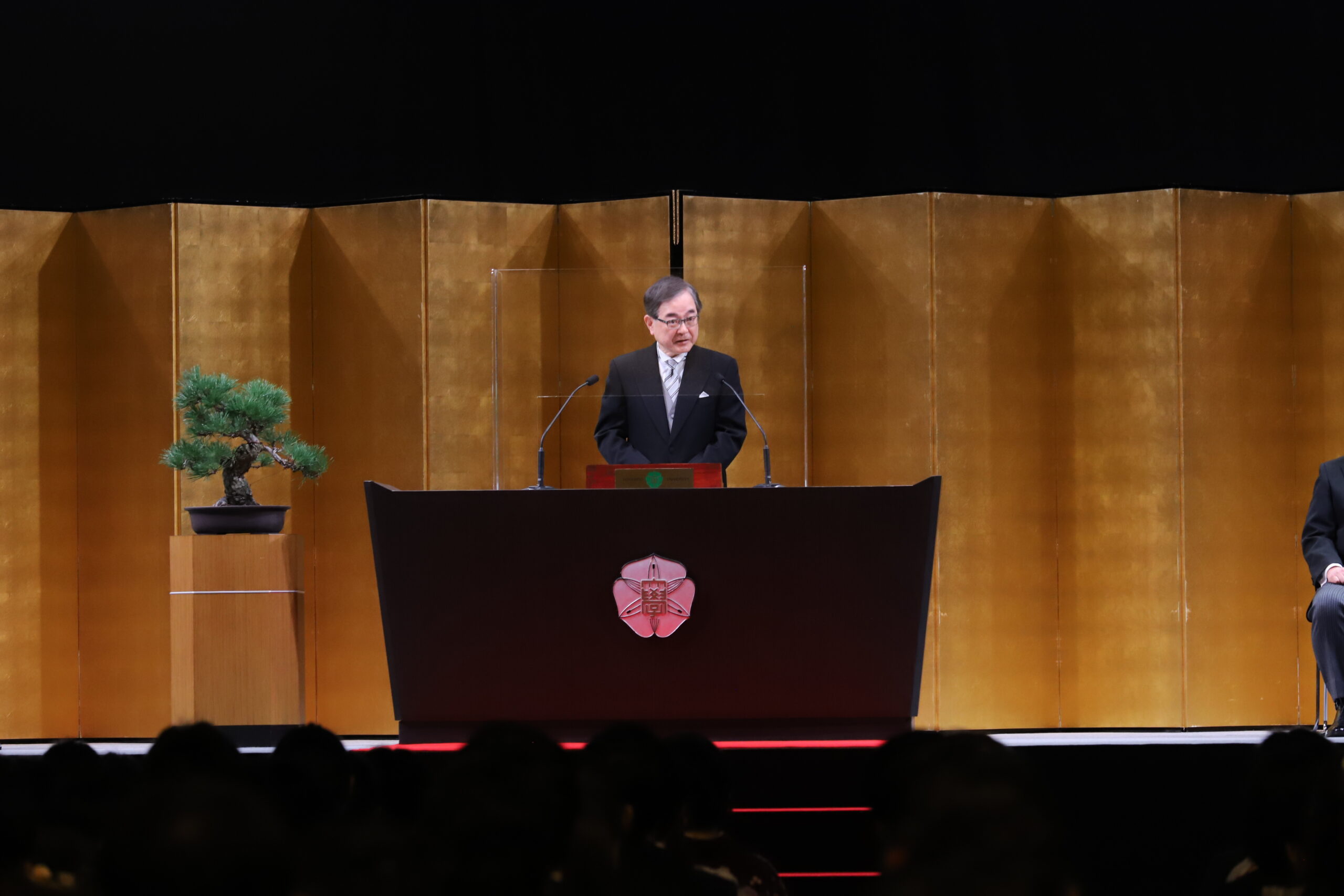 President Houkin on the podium delivering his farewell address