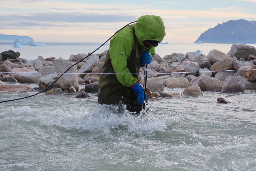 Traditional methods of estimating glacier discharge involve water depth measurements, a physically demanding task that requires wading into the fast flowing, freezing cold water (Photo: Shin Sugiyama).