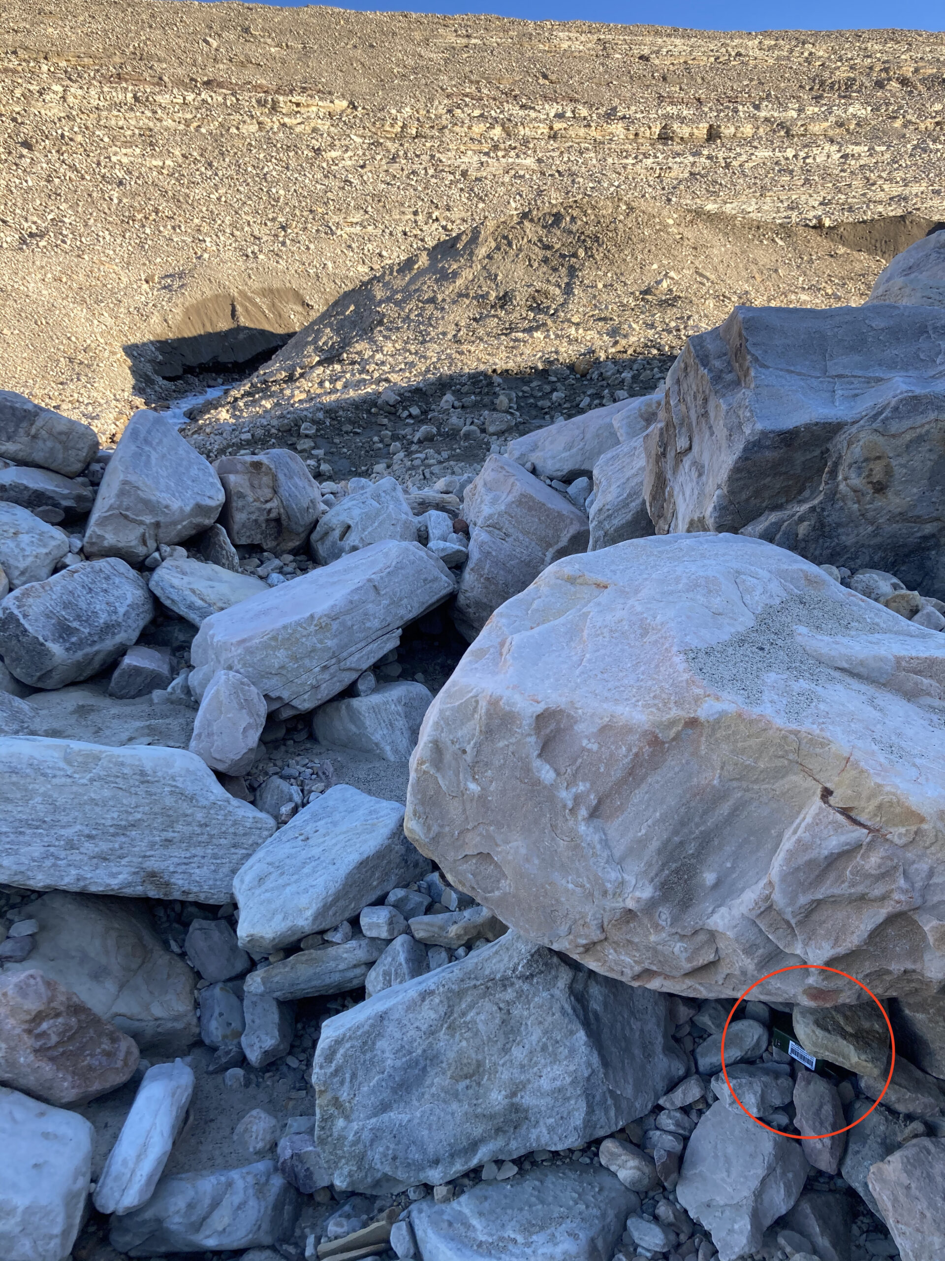 In the proposed method, an acoustic sensor is deployed in a sheltered location (red circle, bottom right, under the large rock) near the glacier to continuously record sounds; a much easier and simpler process (Photo: Evgeny Podolskiy).