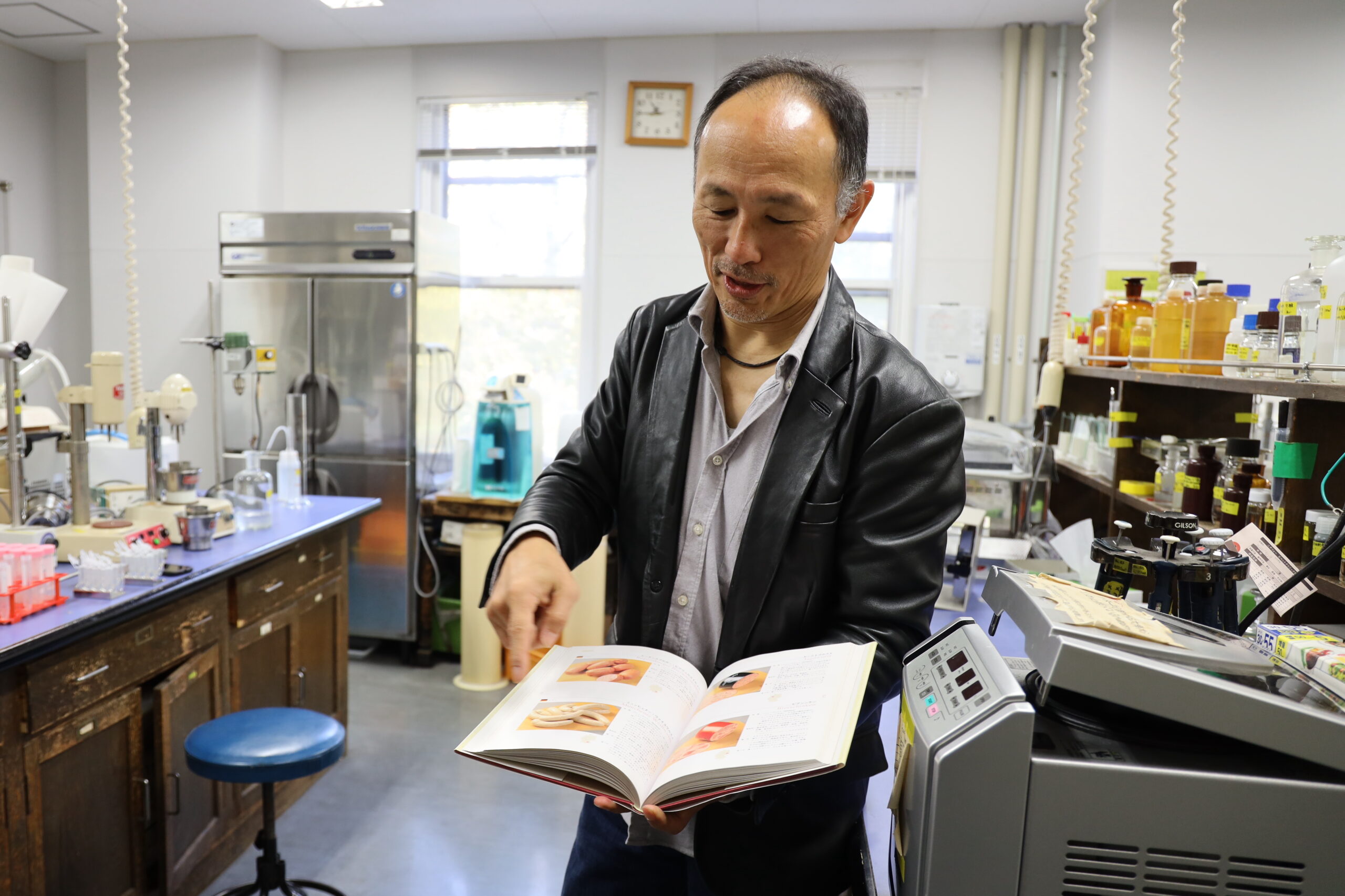 Wakamatsu with a book on the cured meats of Europe—to which he made large contributions. (Photo: Yuka Saito)